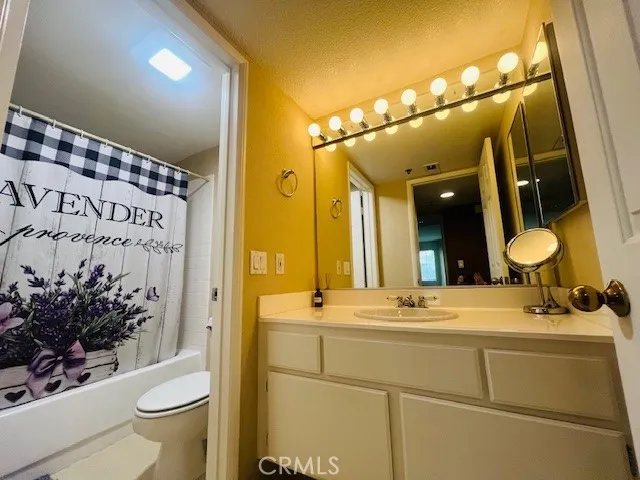 a bathroom with a shower toilet and tub