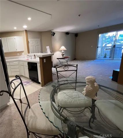 a kitchen with kitchen island a counter top space a sink stainless steel appliances and cabinets