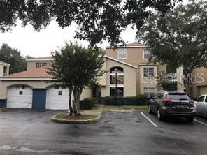 7270 Westpointe Boulevard, Unit 920 Orlando, FL 32835 - Photo 1 of 1 a car parked in front of white house