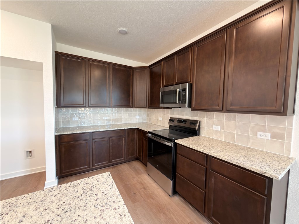 6053 Badger Street Bryan, TX 77807 - Photo 6 of 13 a kitchen with a sink stove and cabinets