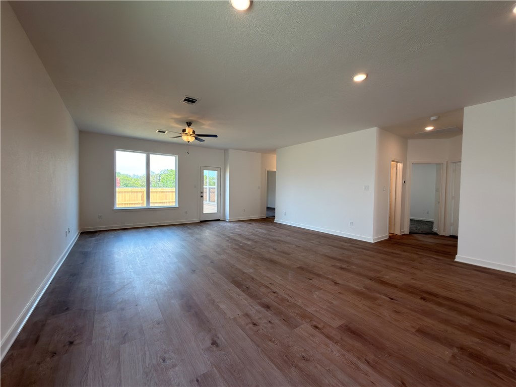 6053 Badger Street Bryan, TX 77807 - Photo 7 of 13 an empty room with wooden floor and windows