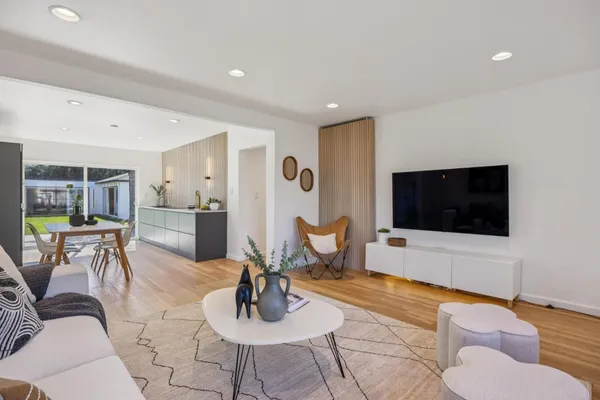 a living room with furniture and wooden floor
