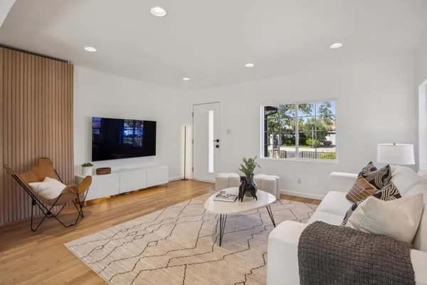 a view of a dining room with furniture and wooden floor
