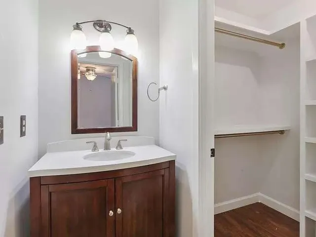 a bathroom with a sink vanity and a mirror