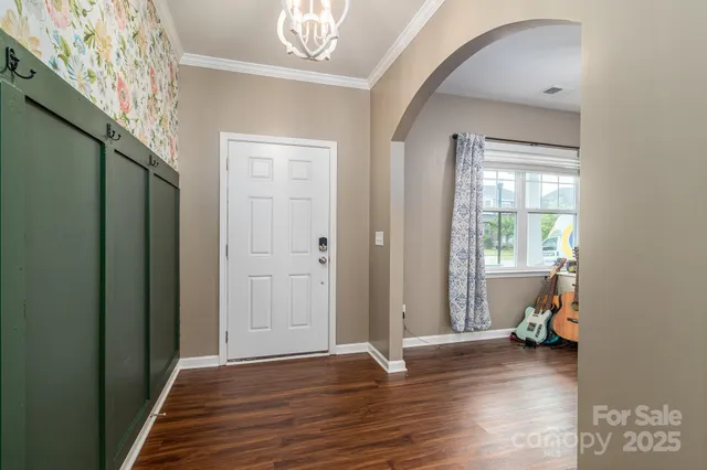 a kitchen with stainless steel appliances granite countertop a sink and a stove with wooden floor