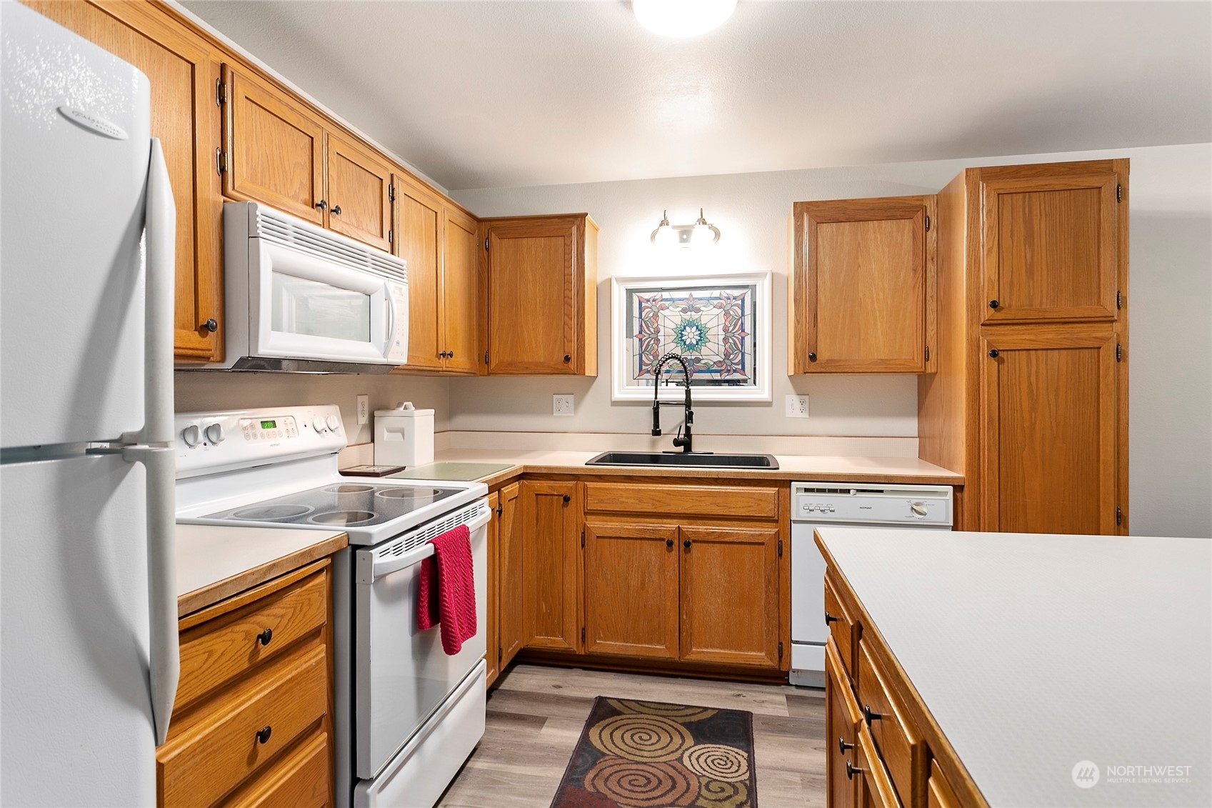 107 Fairside Drive, Unit 25 Lynden, WA 98264 - Photo 9 of 29 a kitchen with stainless steel appliances granite countertop a sink stove and refrigerator
