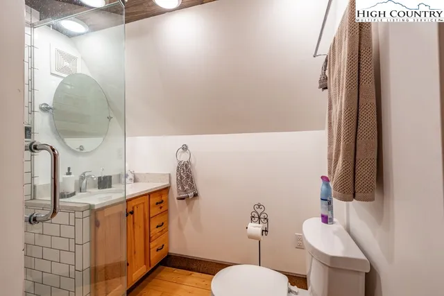 a bathroom with a tub a sink and a large window