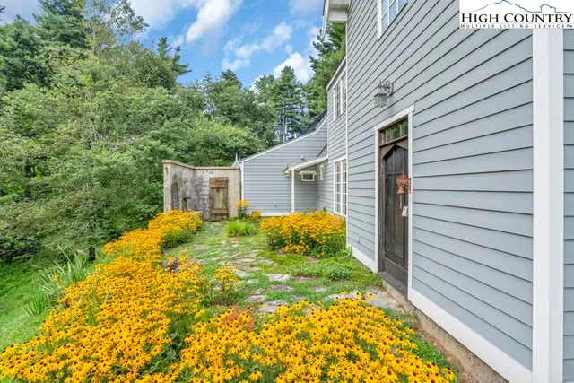 a view of house with backyard and garden