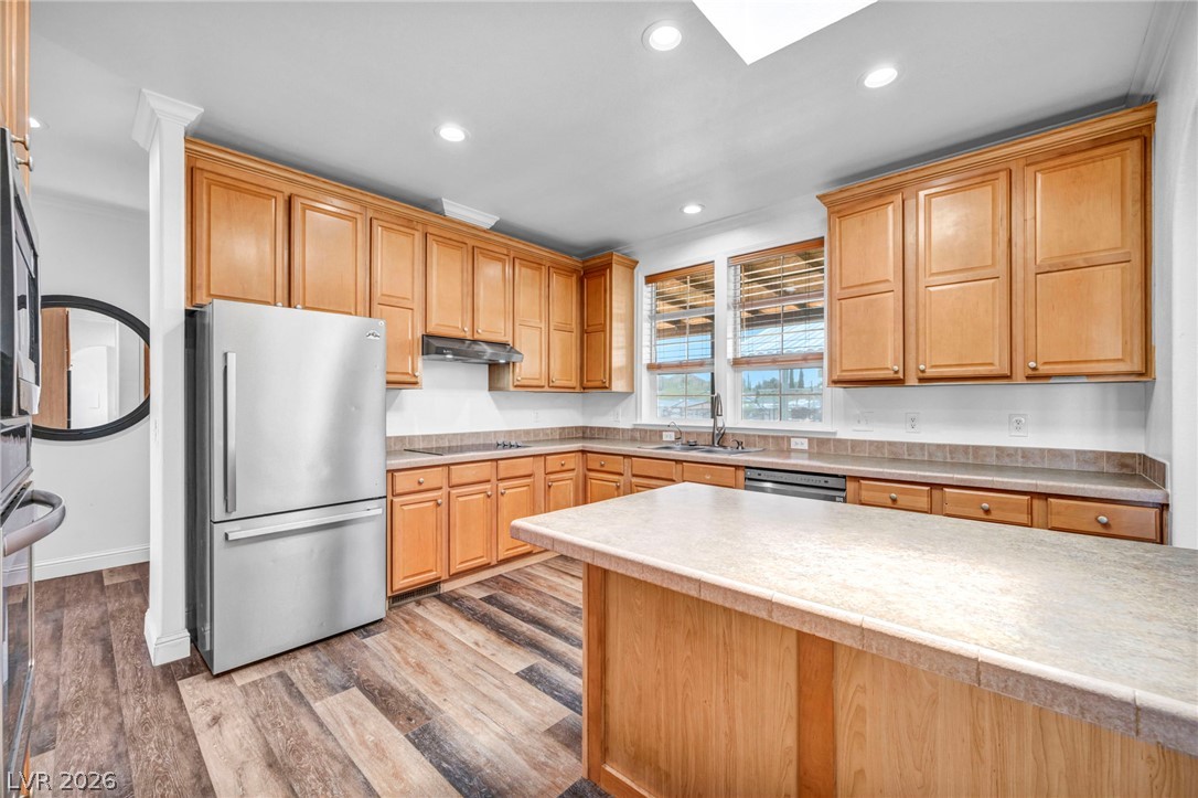225 California Street Searchlight, NV 89046 - Photo 20 of 64 A well-equipped kitchen features a central island, ample wood cabinetry, and a full suite of modern appliances.