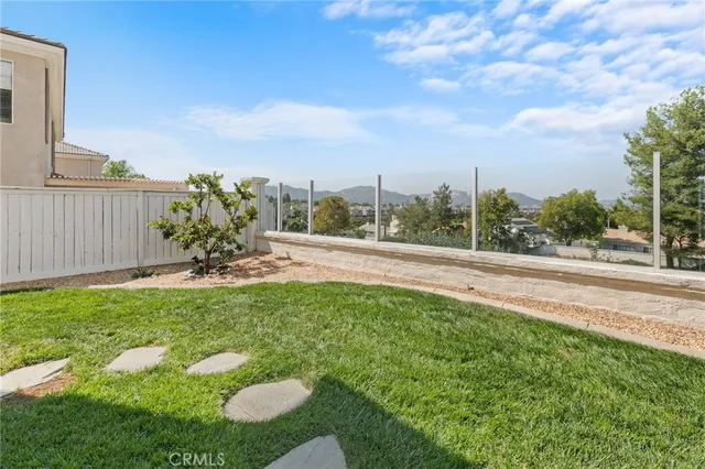 a view of a house with backyard sitting area and garden