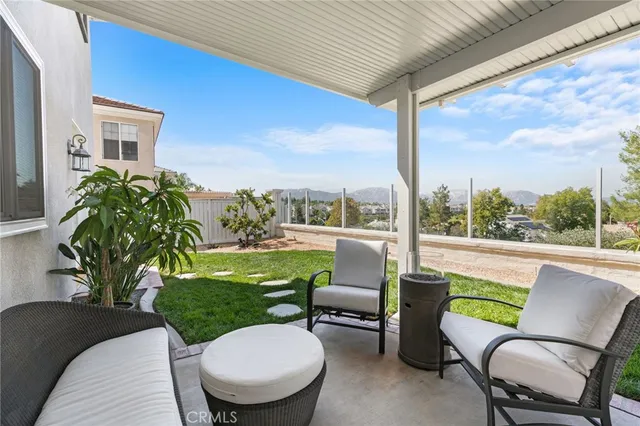 a swimming pool with outdoor seating and yard
