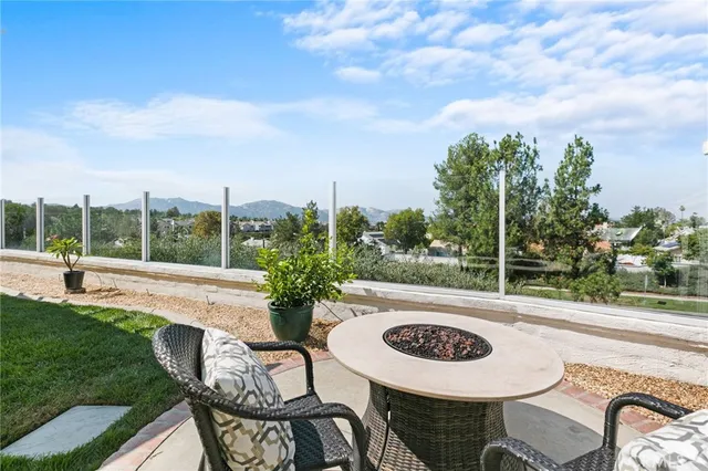 an aerial view of a house with swimming pool and large trees