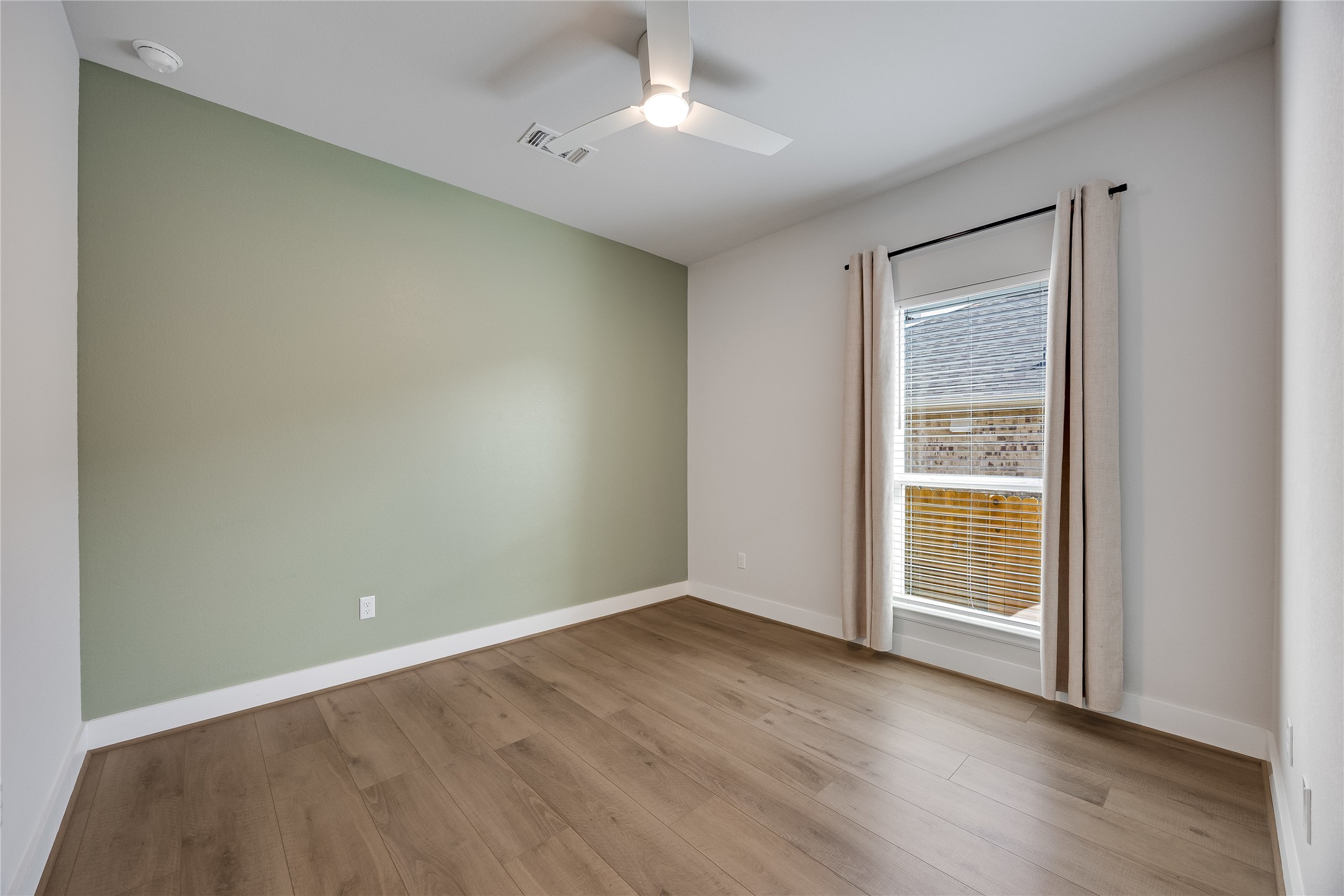 200 Grn Knl Lane Georgetown, TX 78628 - Photo 24 of 32 an empty room with wooden floor cabinet and windows