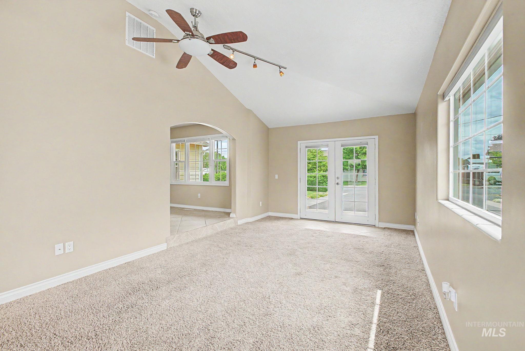 3314 6th Street Lewiston, ID 83501 - Photo 18 of 50 Vaulted ceiling with a ceiling fan, light beige walls, and light-colored carpet