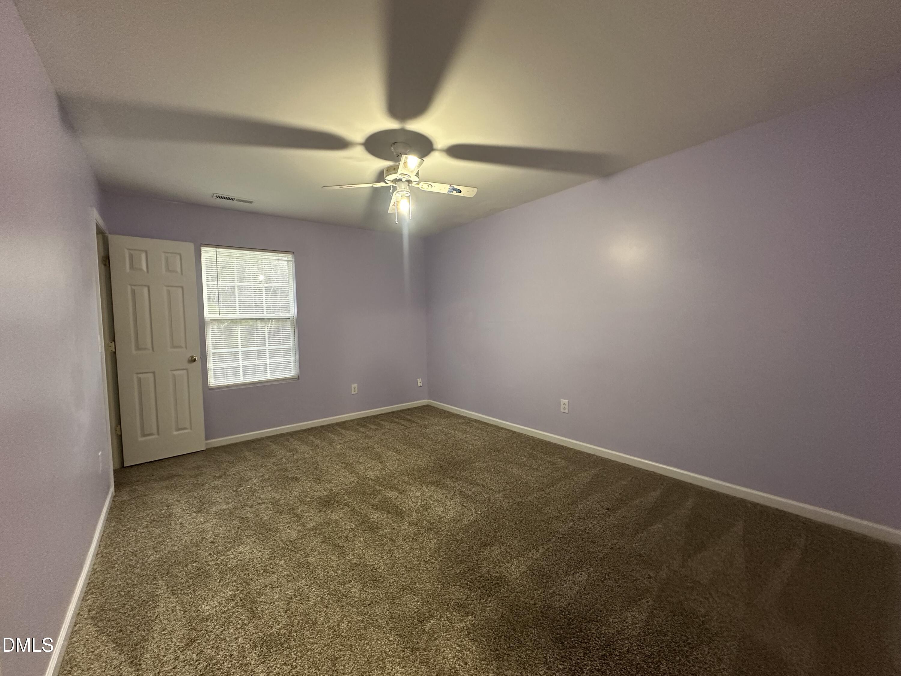 1220 Arbor Greene Drive Garner, NC 27529 - Photo 12 of 17 an empty room with windows and fan