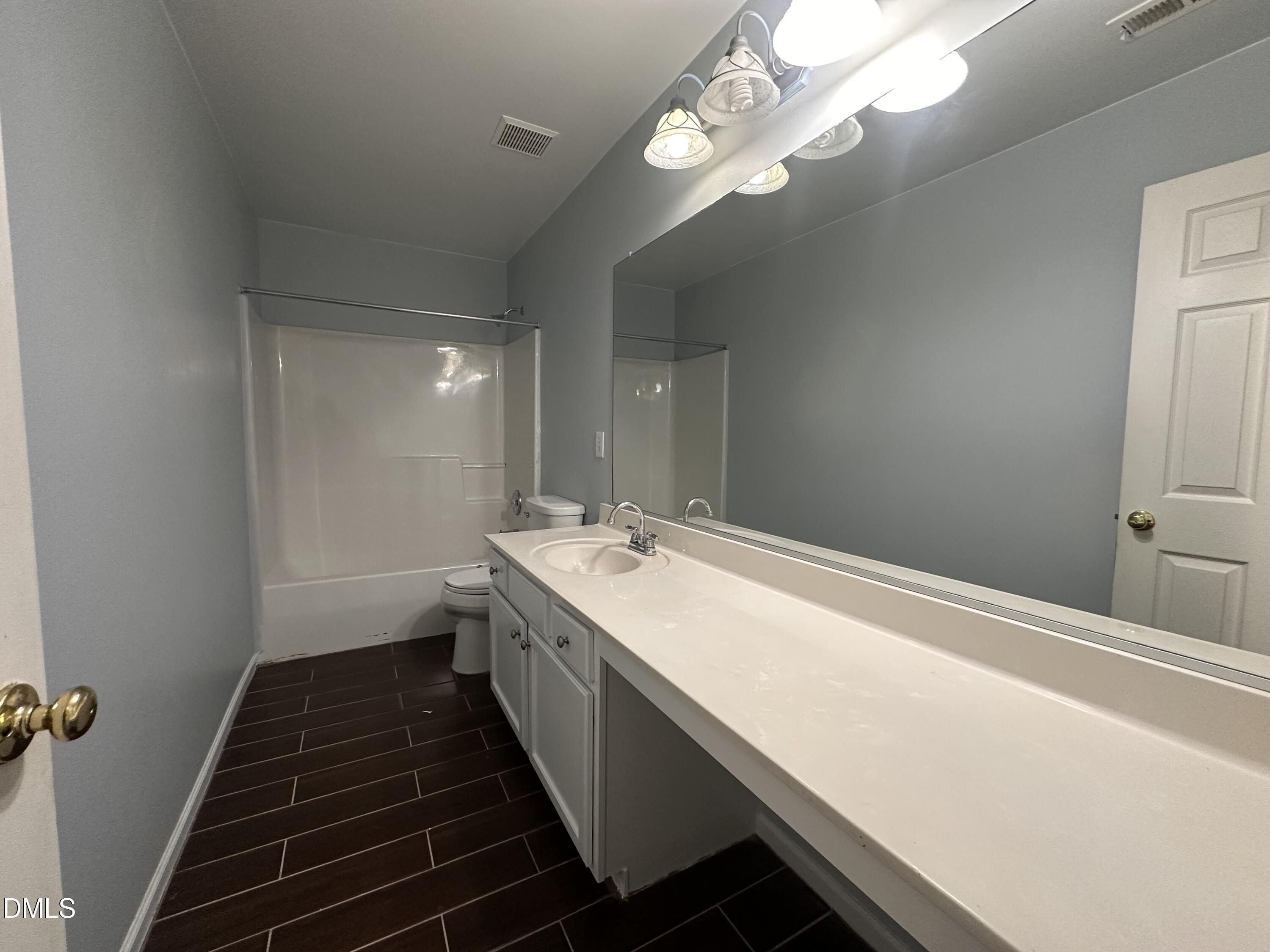 1220 Arbor Greene Drive Garner, NC 27529 - Photo 15 of 17 a bathroom with a double vanity sink and a mirror