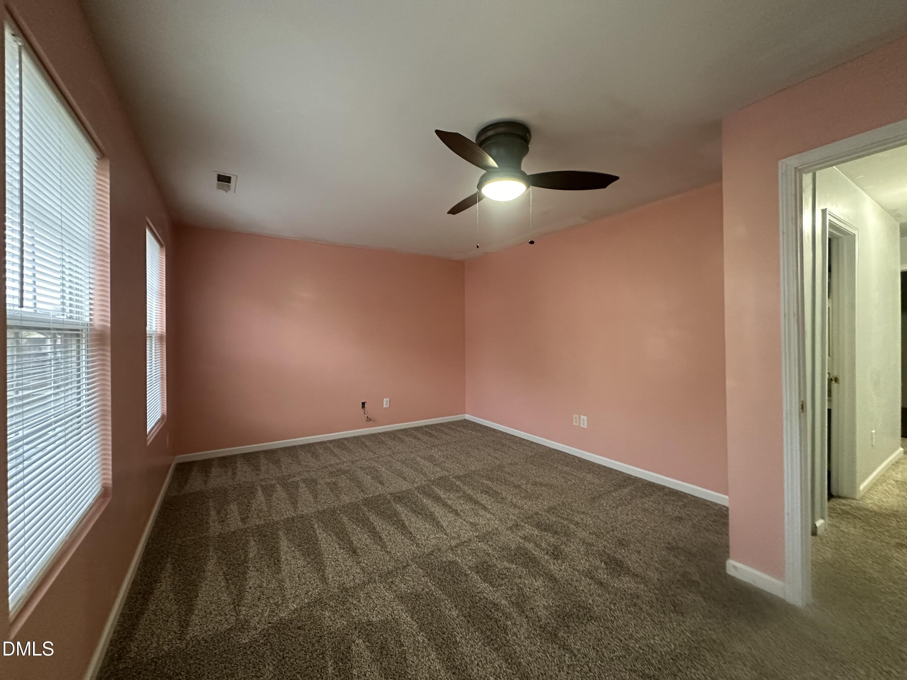 1220 Arbor Greene Drive Garner, NC 27529 - Photo 17 of 17 en empty room with windows and ceiling fan