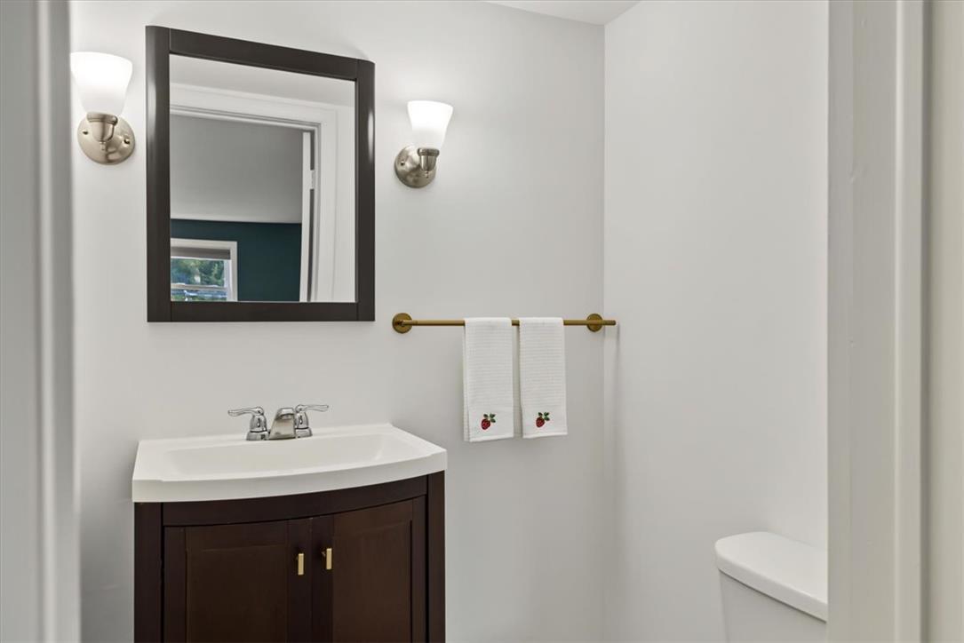 303 Cedar Road Hellertown, PA 18055 - Photo 15 of 27 A compact vanity with elegant sconce lighting creates a functional and inviting powder room.