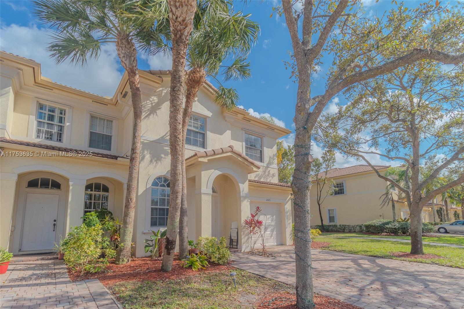 2695 Southwest 84th Terrace, Unit 104 Miramar, FL 33025 - Photo 2 of 36 a front view of a house with garden