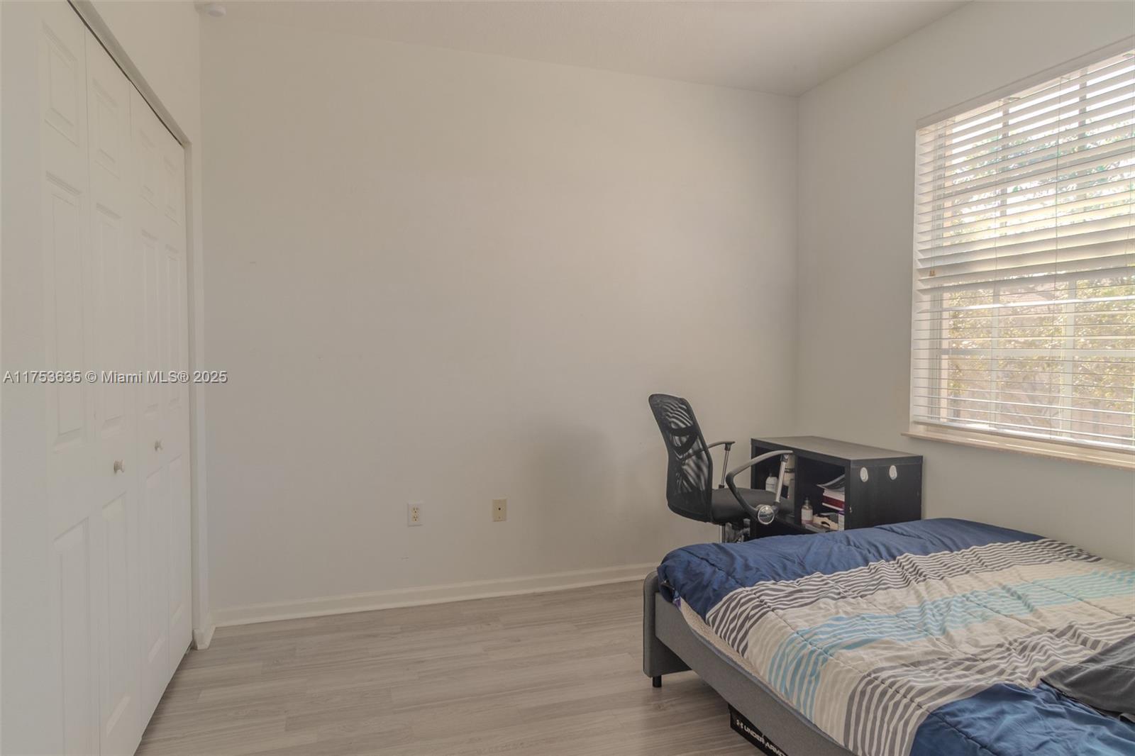 2695 Southwest 84th Terrace, Unit 104 Miramar, FL 33025 - Photo 24 of 36 a bedroom with a bed and window