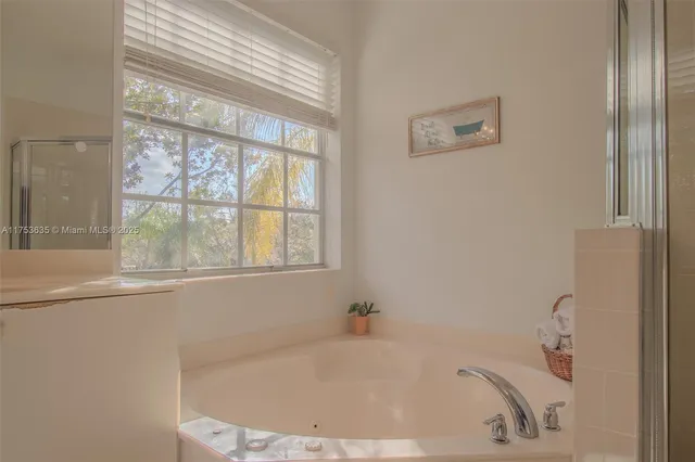 a view of a house with a big yard and large trees