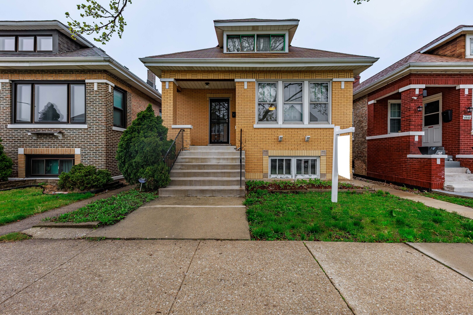 4941 South Kolin Avenue Chicago, IL 60632 - Photo 2 of 17 a front view of a house with a garden