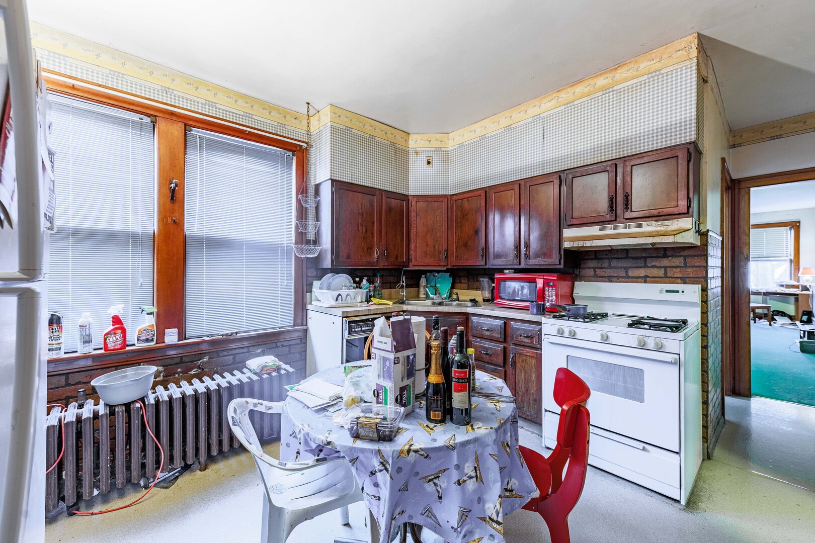 4941 South Kolin Avenue Chicago, IL 60632 - Photo 9 of 17 a kitchen with a refrigerator and a dining table