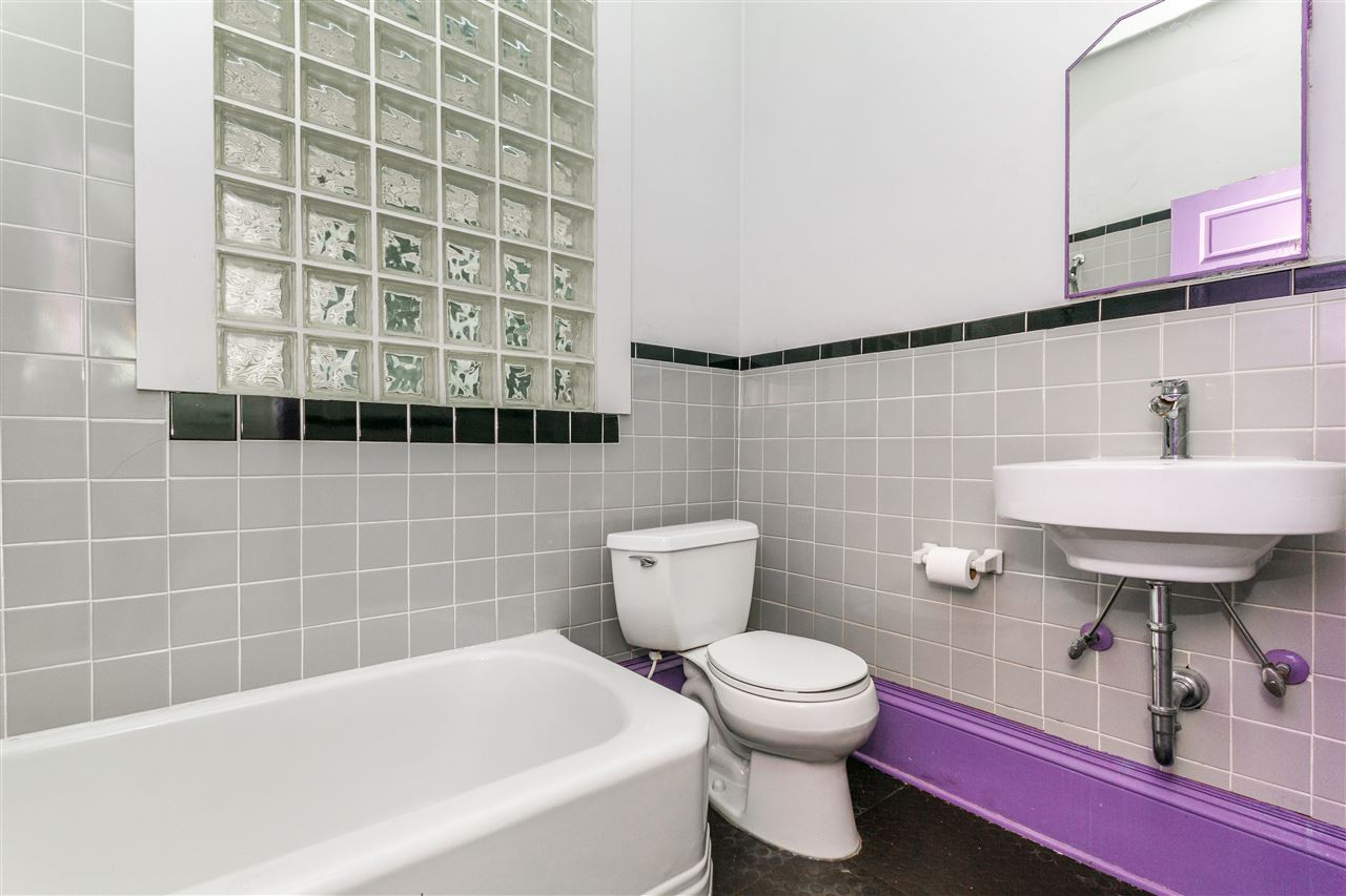 2200 Hope Street Raleigh, NC 27607 - Photo 16 of 25 a bathroom with a sink a toilet and a mirror