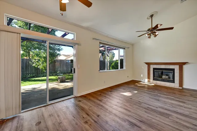an empty room with floor to ceiling windows and a fireplace