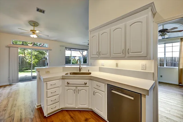 a kitchen with stainless steel appliances granite countertop a sink and cabinets