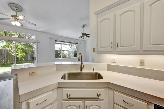 a kitchen with a sink cabinets and window