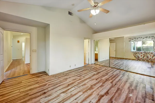 a view of empty room with wooden floor
