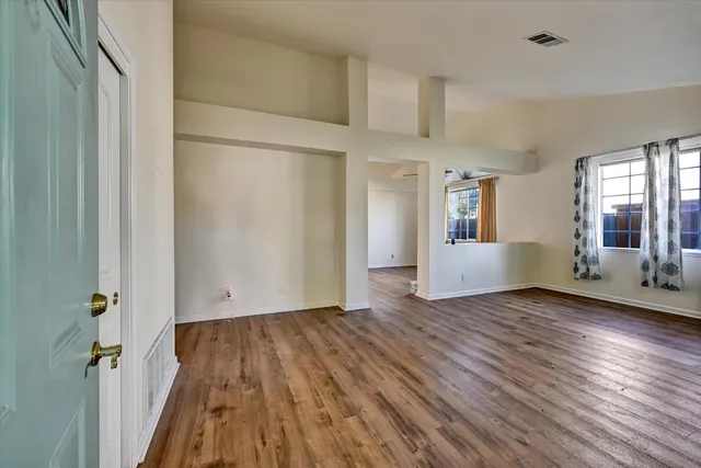 wooden floor in an empty room with a window