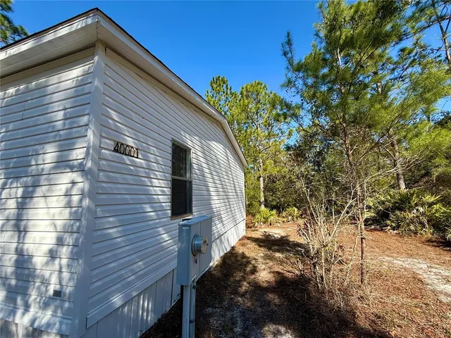 a view of a house with a yard covered in snow