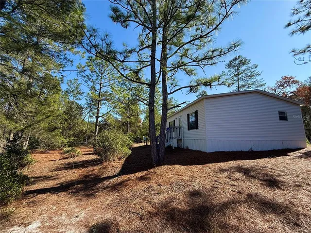 a backyard of a house with lots of green space