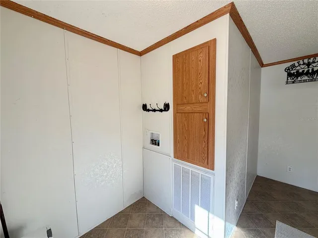 a view of a room with a window and refrigerator