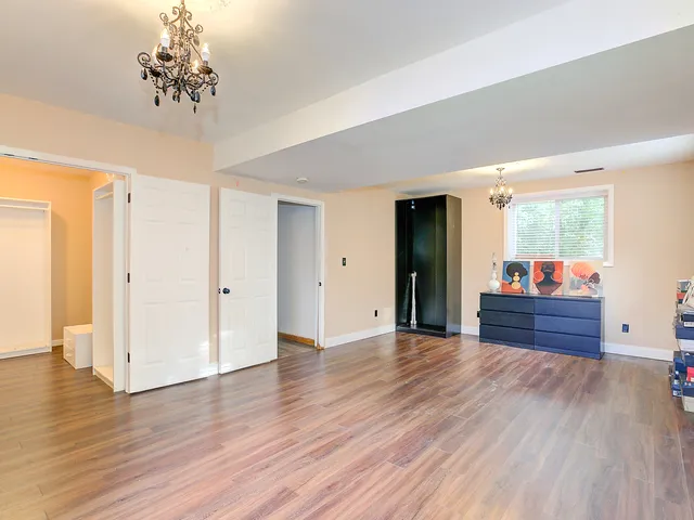 wooden floor in an empty room with a mirror