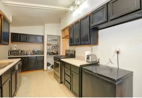 a kitchen with a sink stove and cabinets