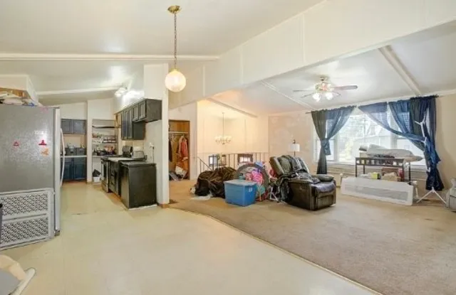 a view of a living room and kitchen area