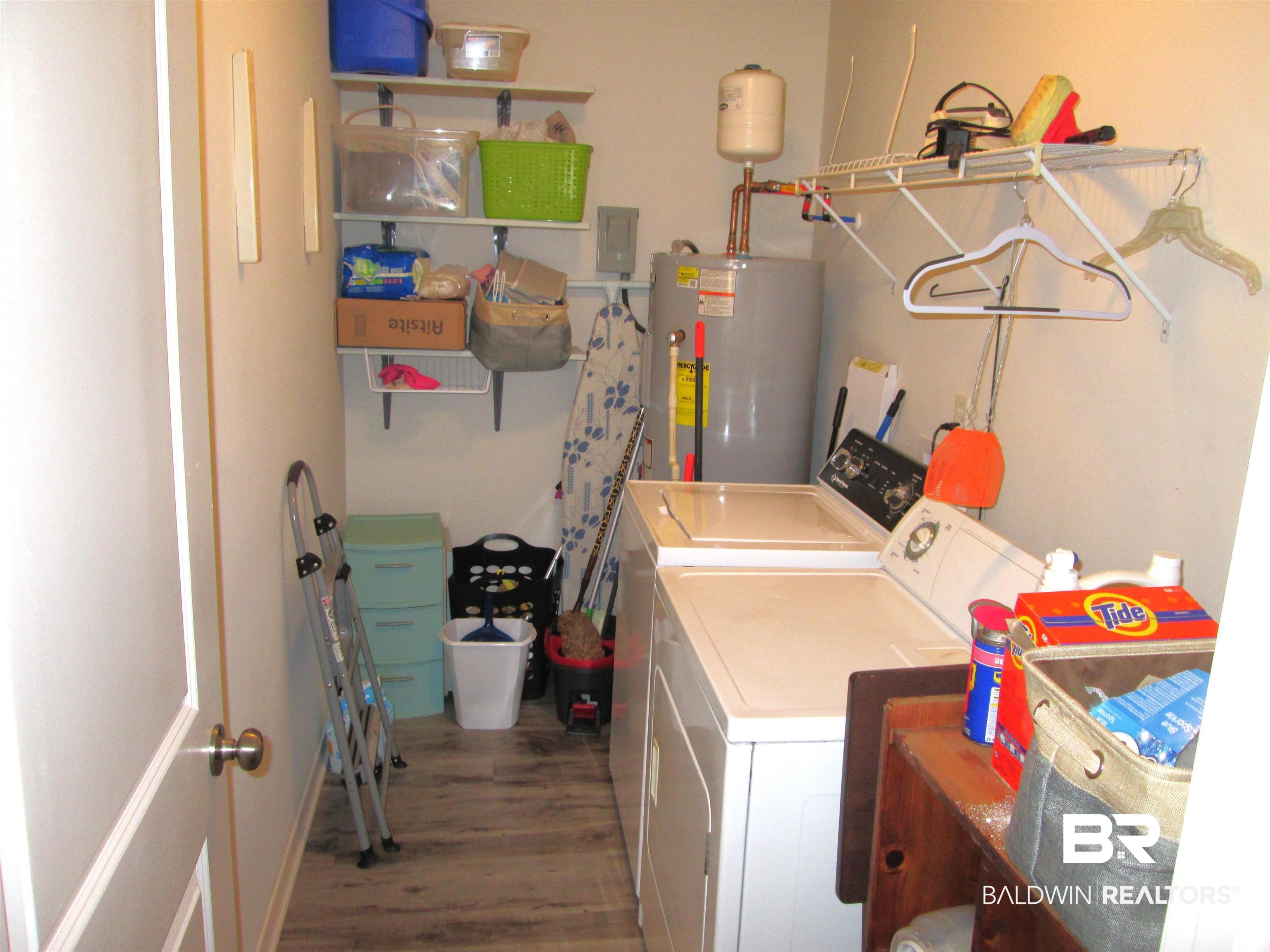 530 Brethren Church Road Fruitdale, AL 36539 - Photo 8 of 24 Washroom with washer and dryer, hardwood / wood-style floors, and water heater