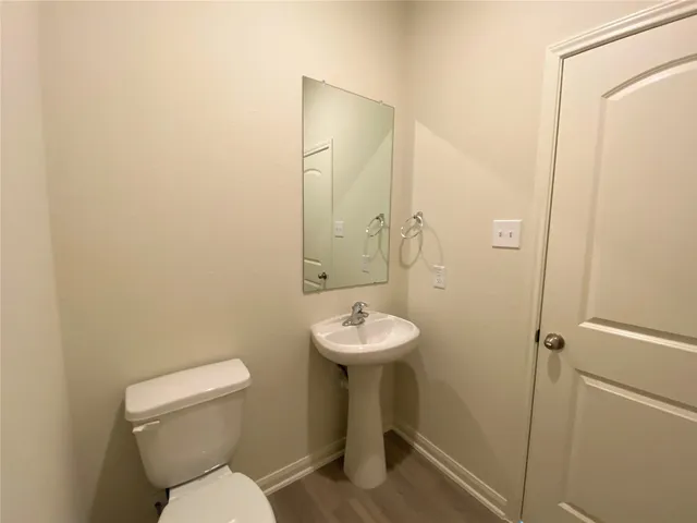 a bathroom with a sink toilet and a mirror