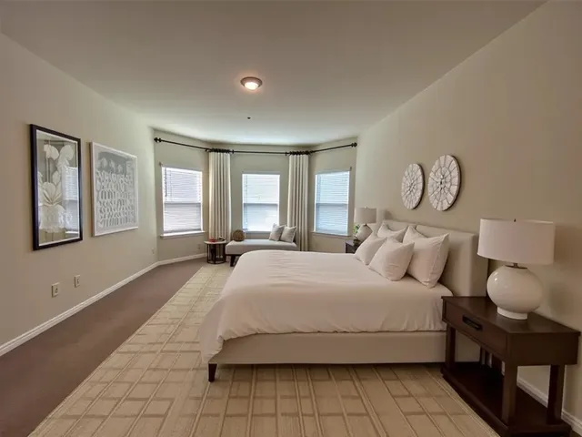 a bedroom with a large bed and a window