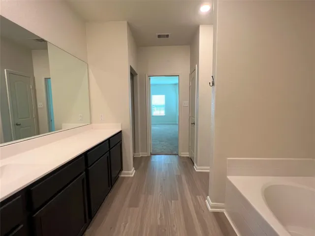 a bathroom with a sink a bathtub and a shower