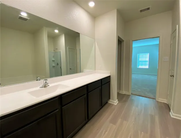 a bathroom with a double vanity sink and mirror