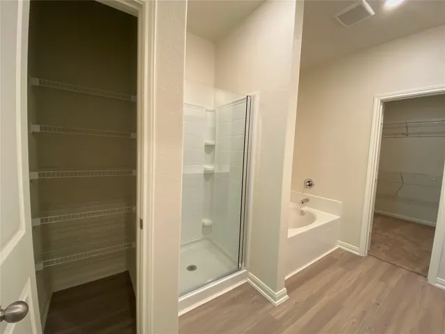 a bathroom with a shower and a sink