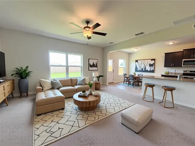 a living room with furniture and a large window