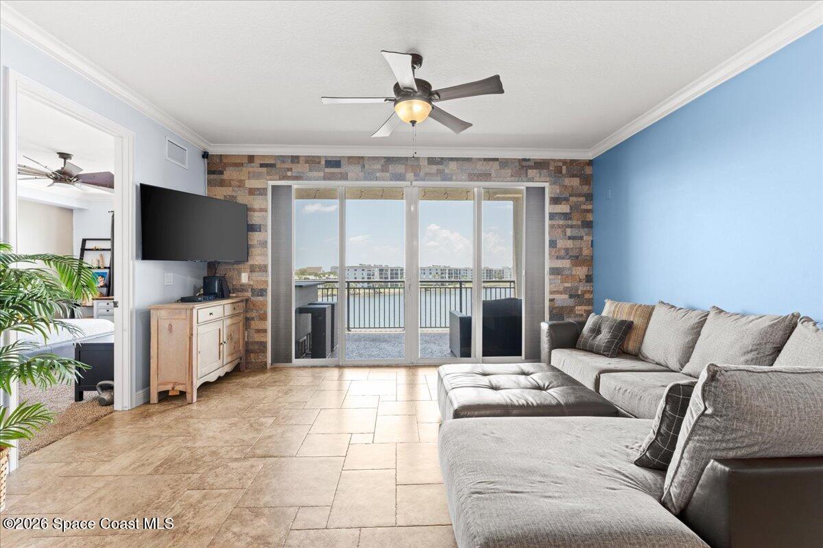 4125 West End Road, Unit 405 Cocoa Beach, FL 32931 - Photo 9 of 44 a living room with furniture and a flat screen tv