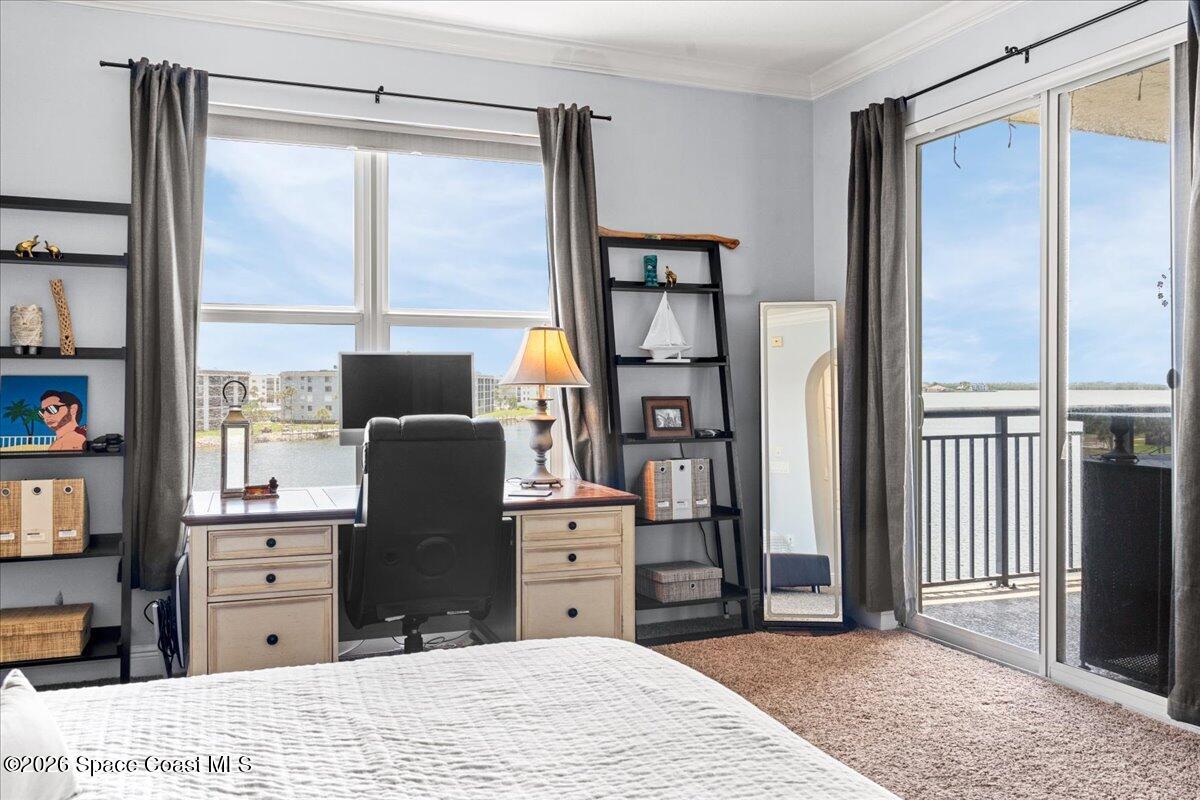 4125 West End Road, Unit 405 Cocoa Beach, FL 32931 - Photo 16 of 44 a bed room with a bed and a television