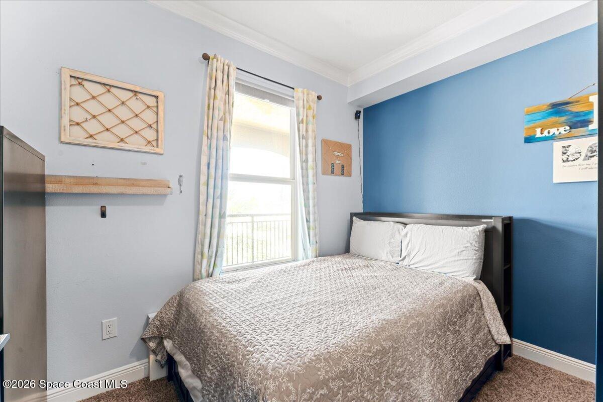 4125 West End Road, Unit 405 Cocoa Beach, FL 32931 - Photo 20 of 44 a bedroom with a bed and a window
