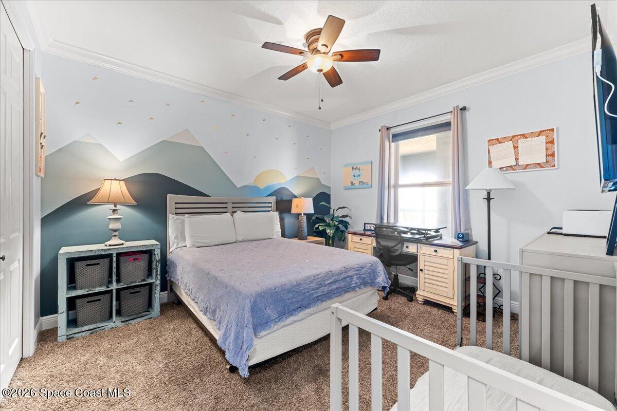 4125 West End Road, Unit 405 Cocoa Beach, FL 32931 - Photo 23 of 44 a bed room with a bed and a chandelier